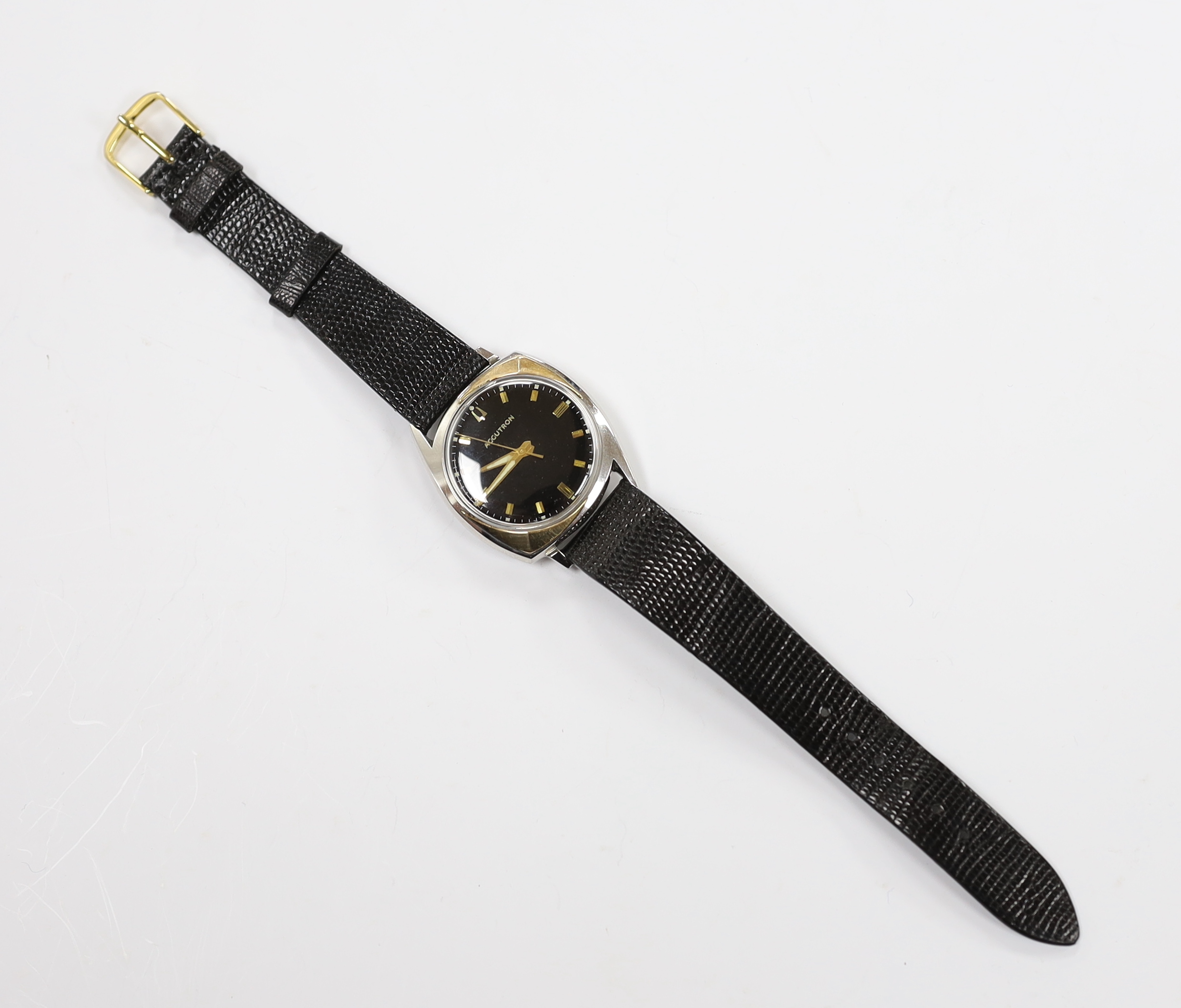 A gentleman's stainless steel Bulova Accutron wrist watch, with black dial, on an Accutron strap, case diameter 33mm.